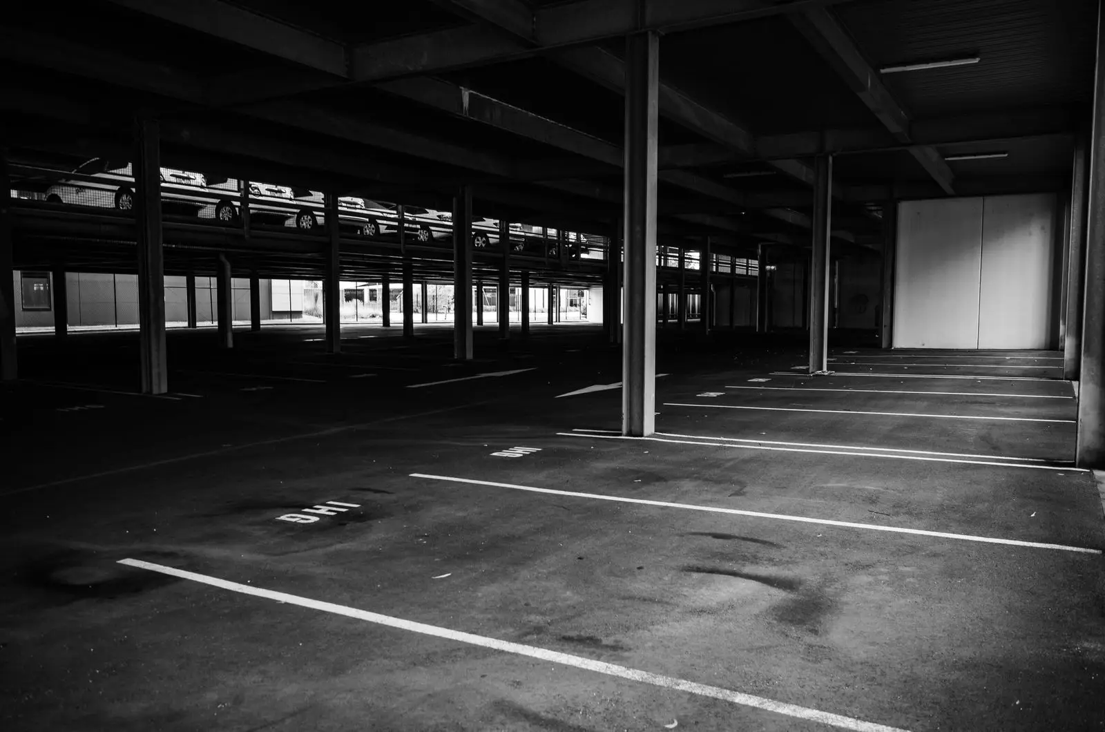 The parking area outside the unit, with painted bays