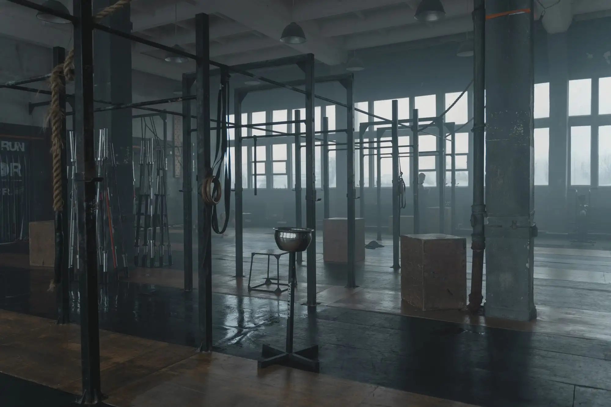 The training floor at Forge before anyone arrives, racks along the long wall