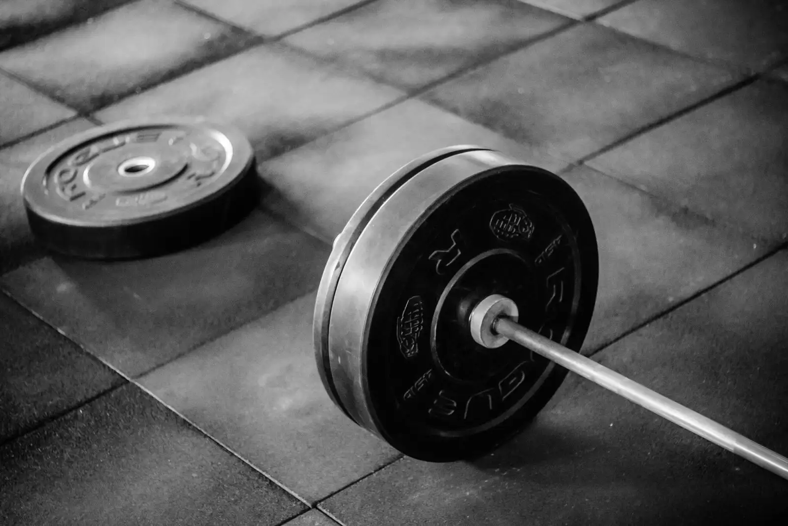 A loaded barbell on the rubber floor of the gym